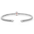 Signature Caviar Two-Tone Garnet Oval Mini Versa Torque Bracelet in sterling silver with 14K gold accents features caviar beading and a central garnet gemstone.