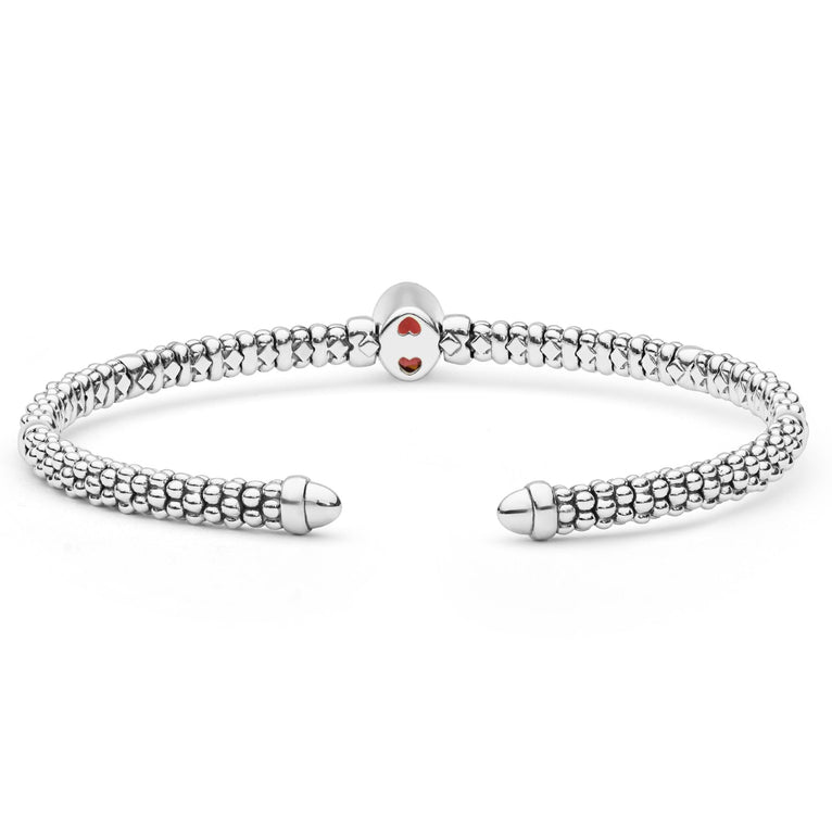Signature Caviar Two-Tone Garnet Oval Mini Versa Torque Bracelet in sterling silver with 14K gold accents features caviar beading and a central garnet gemstone.