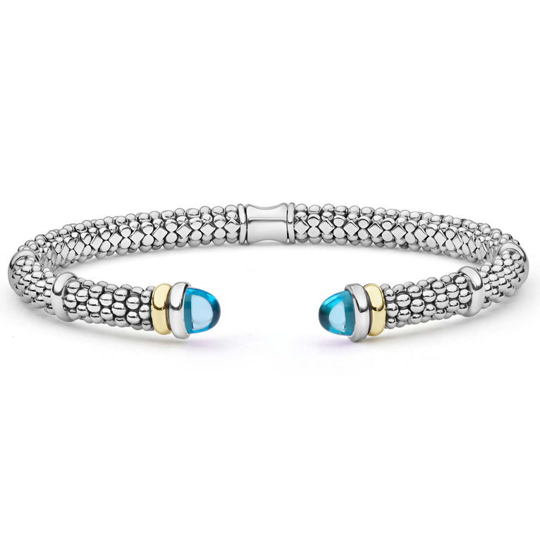 Signature Caviar Two-Tone Swiss Blue Topaz Versa Torque Bracelet in sterling silver with caviar beading and 14K gold accents, featuring blue topaz cabochon end caps.