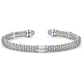 Signature Caviar Two-Tone Swiss Blue Topaz Versa Torque Bracelet in sterling silver with 14K gold accents, featuring caviar beading and vivid sky-blue cabochon end caps.