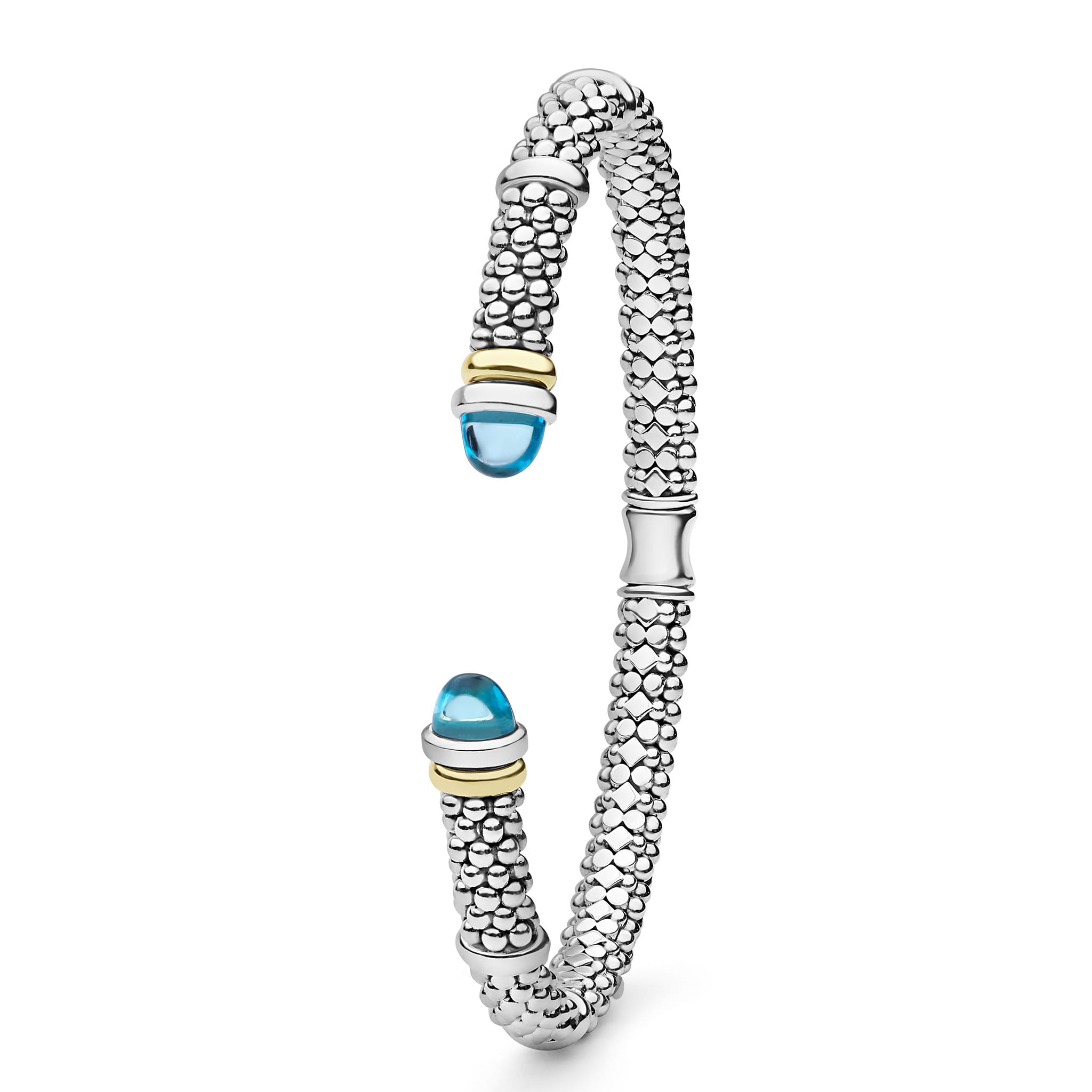 Signature Caviar Two-Tone Swiss Blue Topaz Versa Torque Bracelet in sterling silver, showcasing caviar beading and 14K gold accents with blue topaz cabochon ends.