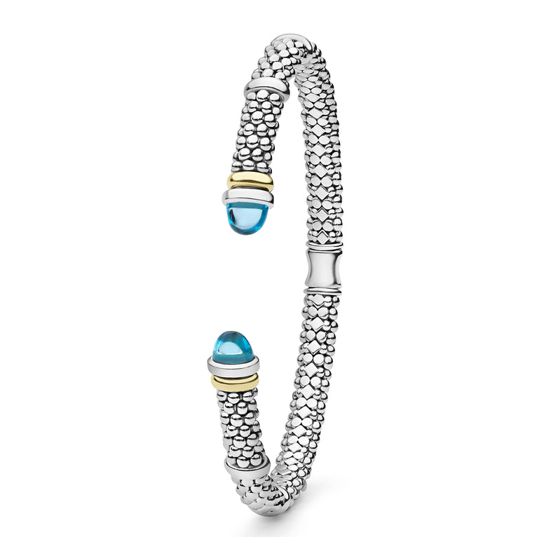 Signature Caviar Two-Tone Swiss Blue Topaz Versa Torque Bracelet in sterling silver, showcasing caviar beading and 14K gold accents with blue topaz cabochon ends.