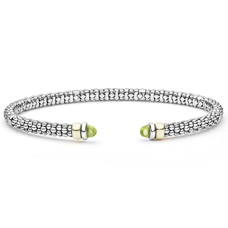 Signature Caviar Two-Tone Peridot Mini Versa Torque Bracelet in sterling silver and 14K gold, featuring caviar beading and green cabochon-cut peridot gemstone end caps.