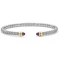  3mm: A sleek sterling silver cuff with 14K gold accents and garnet cabochons, featuring LAGOS's signature Caviar beading.