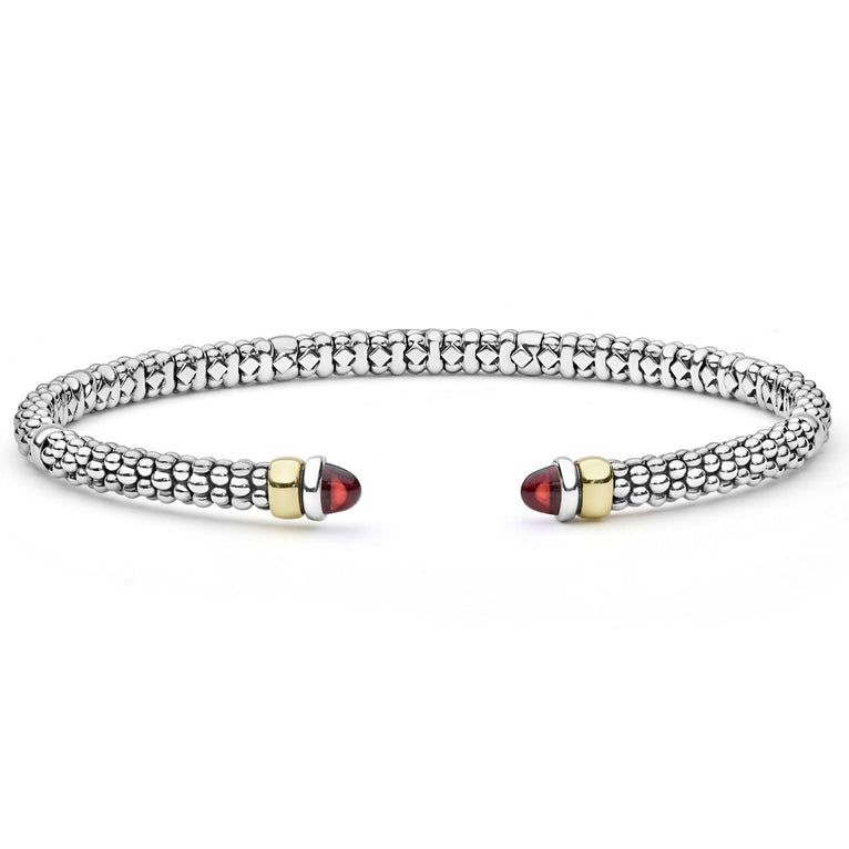  3mm: A sleek sterling silver cuff with 14K gold accents and garnet cabochons, featuring LAGOS's signature Caviar beading.