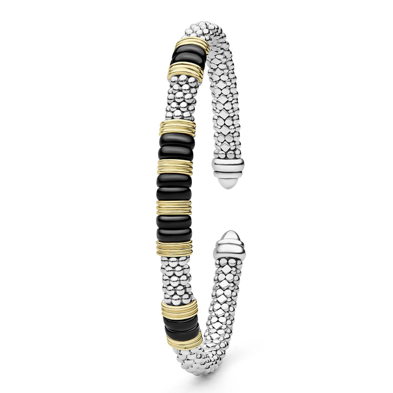 Black Caviar Two-Tone Five Station Black Ceramic Versa Torque Bracelet featuring sterling silver caviar beading and 18K gold accents, elegantly coiled with black ceramic sections.
