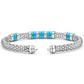 Blue Caviar Two-Tone Five Station Blue Ceramic Versa Torque Bracelet features sterling silver caviar beading, 18K gold accents, and vibrant blue ceramic stations, showcasing elegance and craftsmanship.