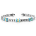 Blue Caviar Two-Tone Three Station Blue Ceramic Versa Torque Bracelet featuring sterling silver caviar beading, 18K gold stations, and vibrant blue ceramic accents.