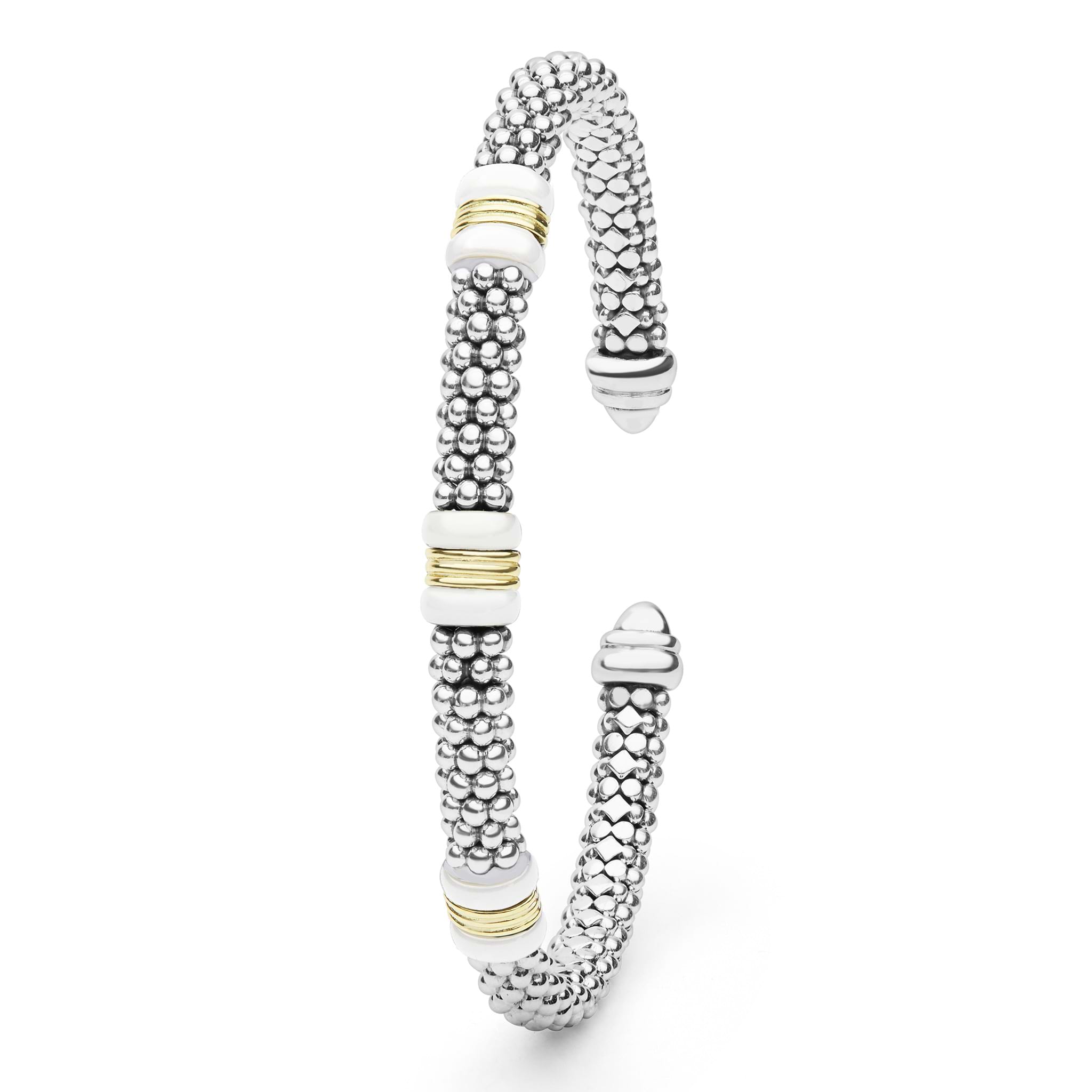 White Caviar Two-Tone Three Station White Ceramic Versa Torque Bracelet features sterling silver caviar beading, 18K gold stations, and white ceramic accents in an open cuff design.