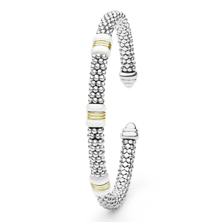 White Caviar Two-Tone Three Station White Ceramic Versa Torque Bracelet features sterling silver caviar beading, 18K gold stations, and white ceramic accents in an open cuff design.