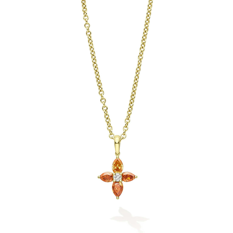 18K gold & orange pear mixed cut diamonds surround a round brilliant cut diamond.