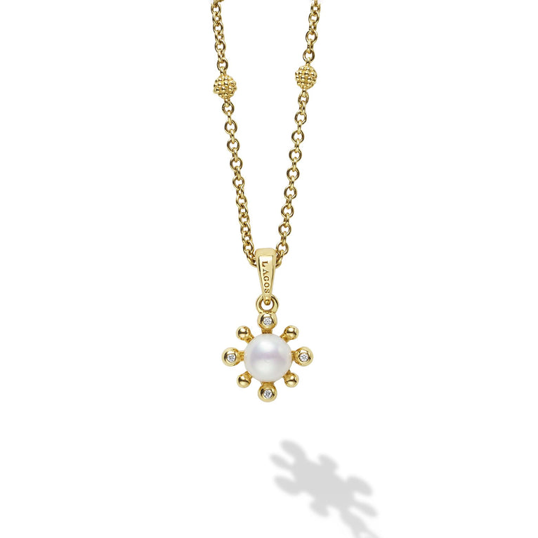 A cultured freshwater pearl framed by diamond fleurs finished on an 18K gold chain detailed with Caviar spheres. Necklace adjusts from 16 to 18 inches. LAGOS diamonds are the highest quality natural stones.