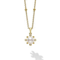 A cultured freshwater pearl framed by diamond fleurs finished on an 18K gold chain detailed with Caviar spheres.