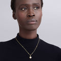 Woman wearing an 18K Gold Fleur Pearl Diamond Pendant Necklace