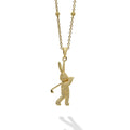 Artfully crafted 18K gold Caviar beaded rabbit pendant playing golf. Accommodates most LAGOS chains.