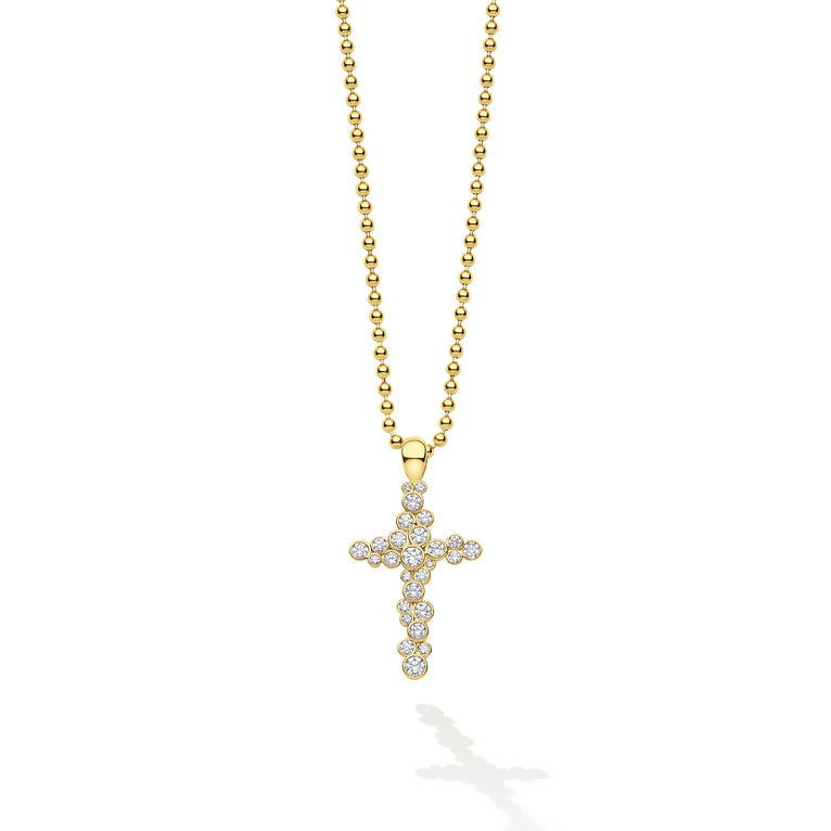 Gold cross pendant necklace on a white background