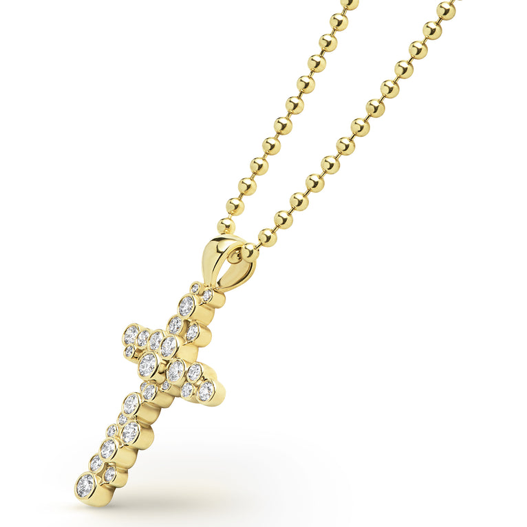 Gold cross pendant necklace with clear stones on a white background