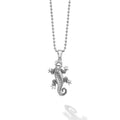 Silver lizard pendant on a chain against a white background