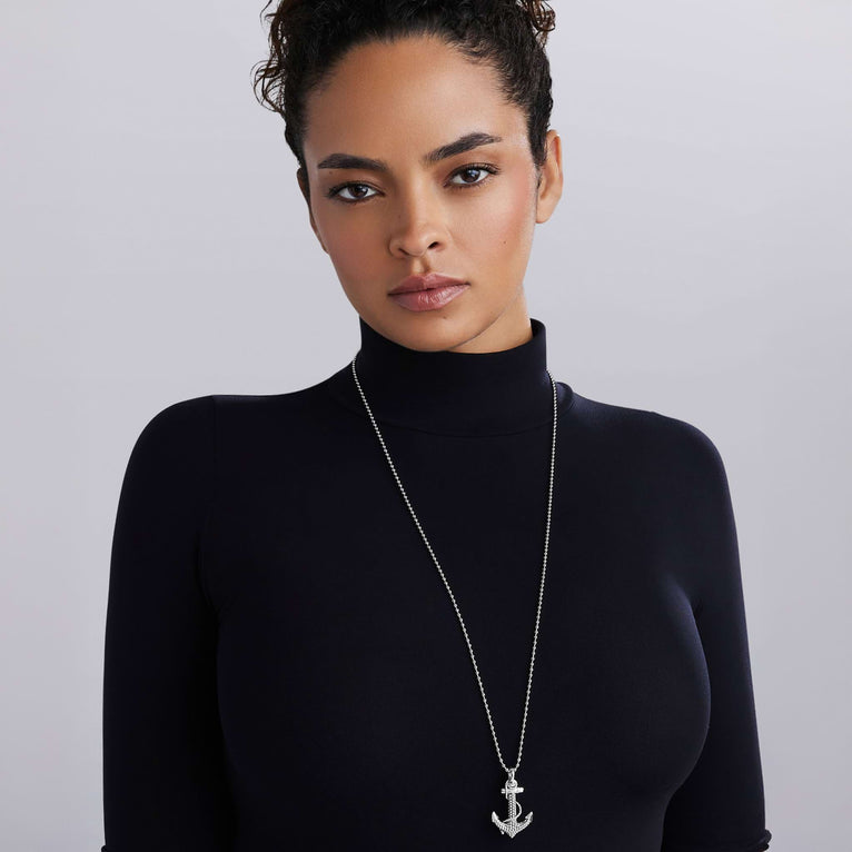 Woman wearing Signature Caviar Sterling Silver Anchor Pendant Necklace featuring a detailed anchor with Caviar beading on a polished ball chain, reflecting refined craftsmanship.