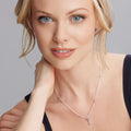 Young woman wearing the Beloved Caviar Key Diamond Pendant Necklace featuring a petite sterling silver key with diamond accents on a silver link chain.