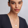 Beloved Heart Pendant Necklace: A delicate silver necklace featuring a polished heart pendant with 18K gold beading, elegantly resting on the collarbone.