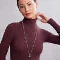 Close-up of a woman wearing the Rare Wonders Large Honeybee Necklace with 18K gold Caviar beading and black rhodium on sterling silver chain.