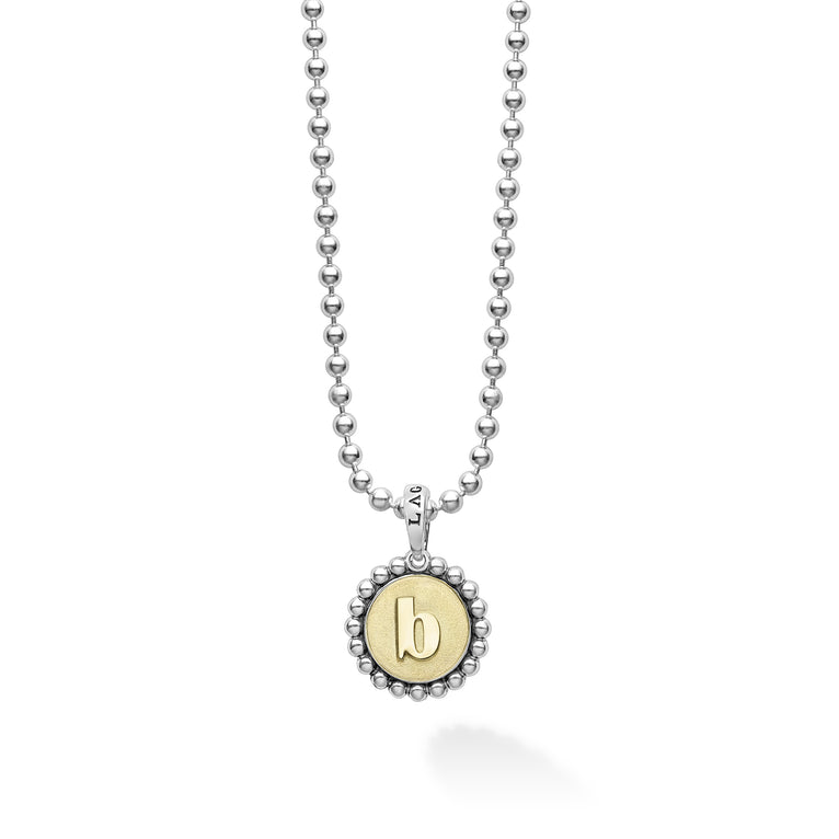 Signature Caviar B Initial Charm Necklace with a sterling silver ball chain and a two-tone pendant, featuring an embossed 18K gold “b” framed by caviar beading.