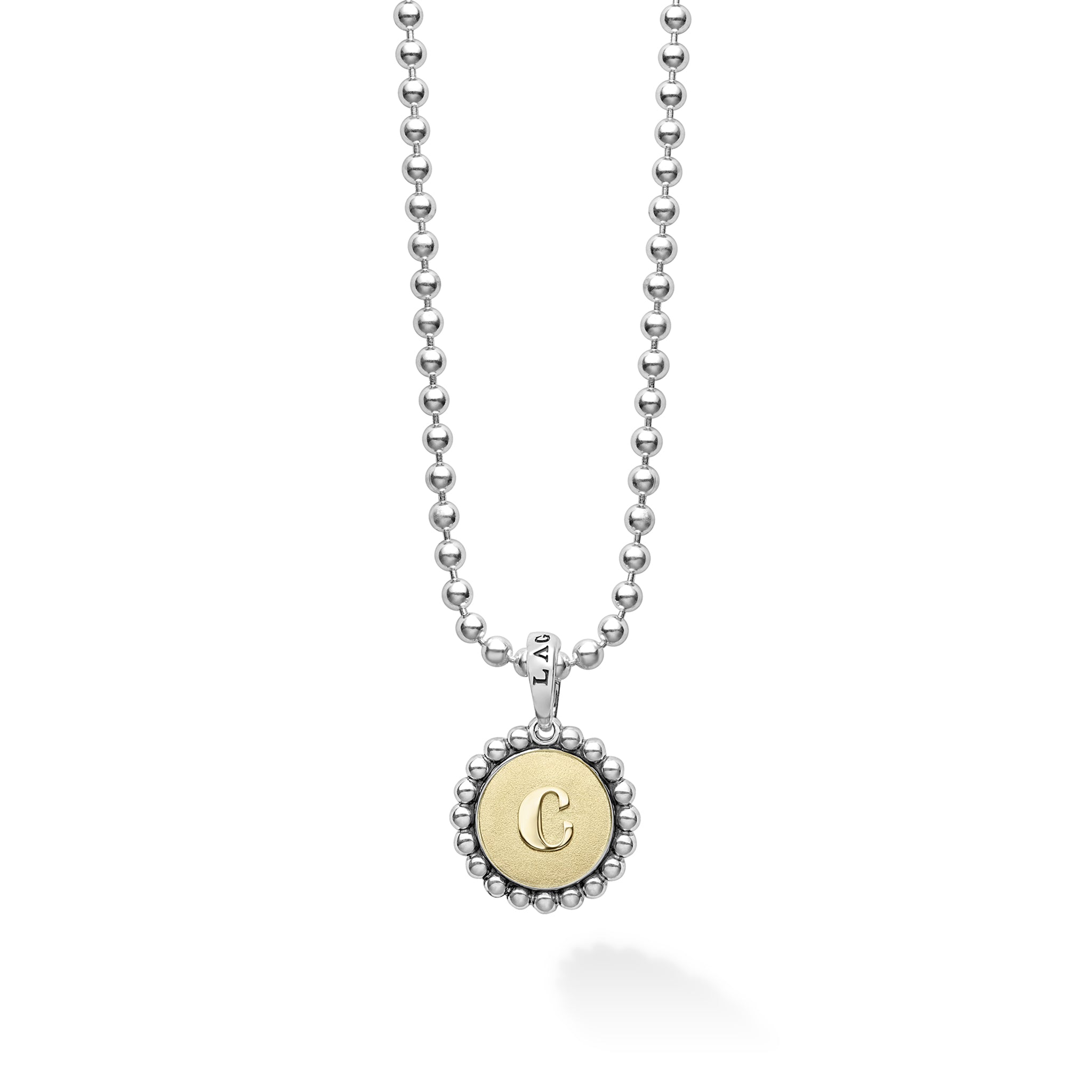 Signature Caviar C Initial Charm Necklace featuring a sterling silver ball chain and an 18K gold disc with a “C” initial, showcasing LAGOS' elegant craftsmanship.