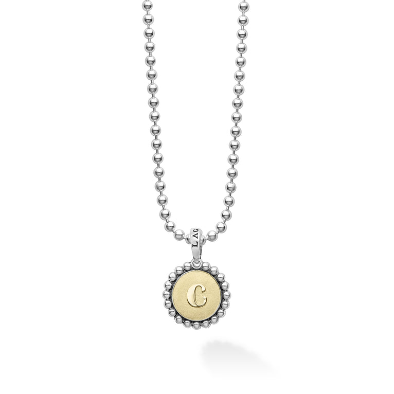 Signature Caviar C Initial Charm Necklace featuring a sterling silver ball chain and an 18K gold disc with a “C” initial, showcasing LAGOS' elegant craftsmanship.