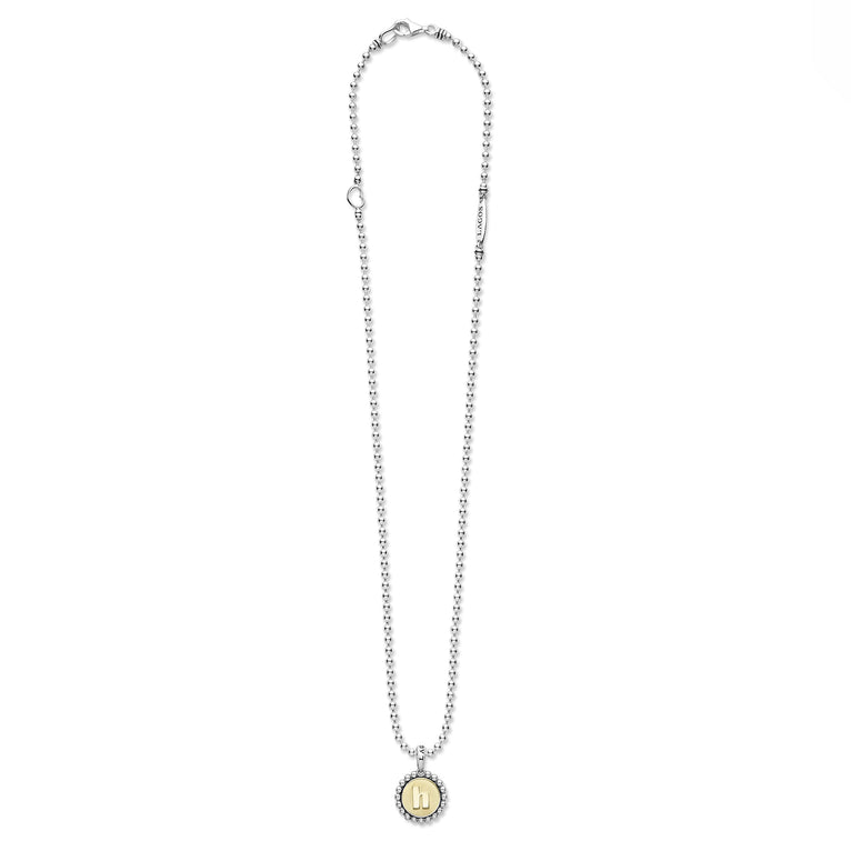 Signature Caviar H Initial Charm Necklace with a sterling silver bead chain and 18K gold h pendant encased in caviar beading, showcasing LAGOS elegance.