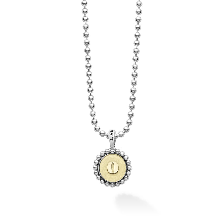 Signature Caviar O Initial Charm Necklace featuring a sterling silver ball chain with an 18K gold 'O' charm, framed by caviar beading, crafted by LAGOS.