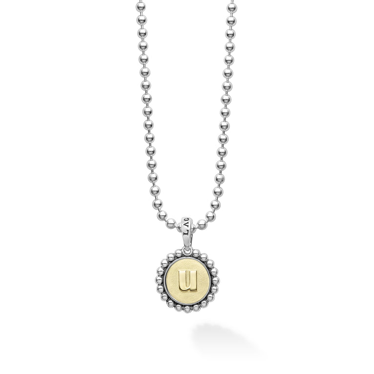 Signature Caviar U Initial Charm Necklace featuring a sterling silver ball chain and 18K gold pendant with caviar beading and a raised u.