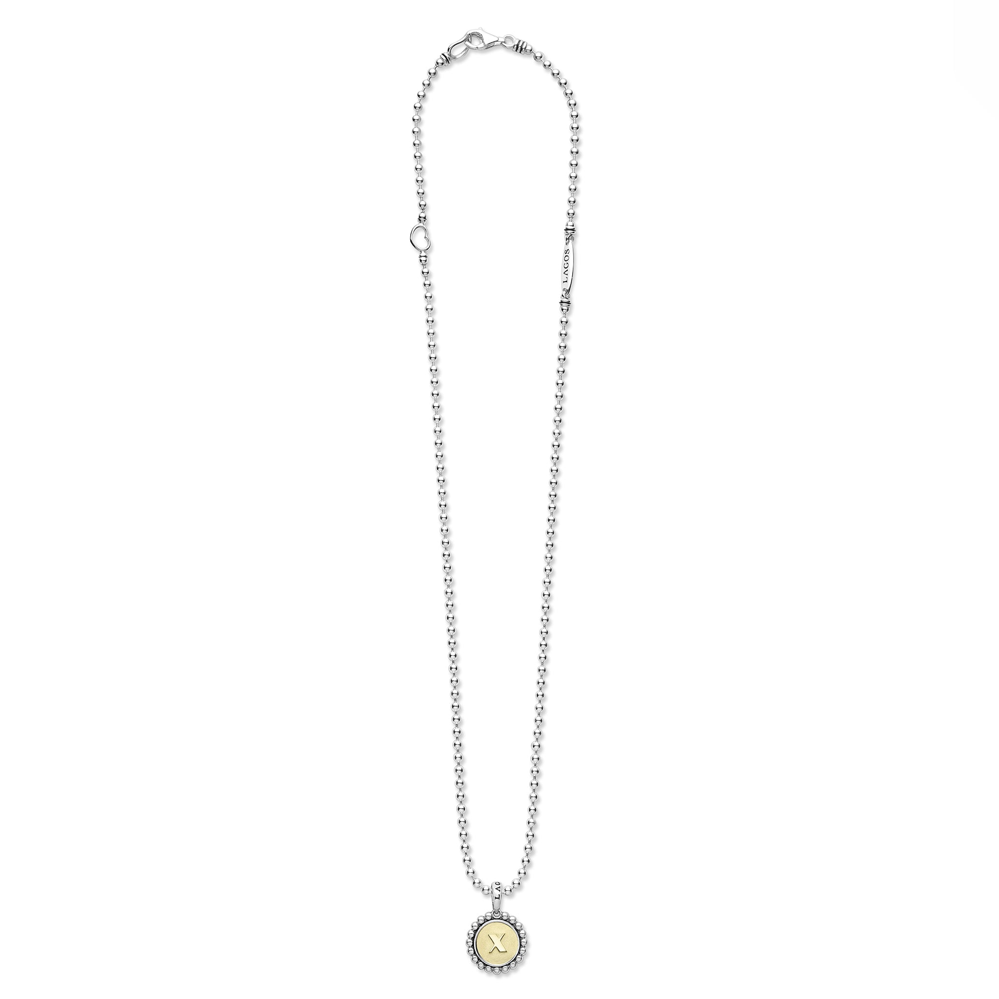 Signature Caviar X Initial Charm Necklace in sterling silver with 18K gold 'X' pendant, caviar beading, heart link, and LAGOS tag.