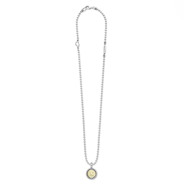 Signature Caviar X Initial Charm Necklace in sterling silver with 18K gold 'X' pendant, caviar beading, heart link, and LAGOS tag.