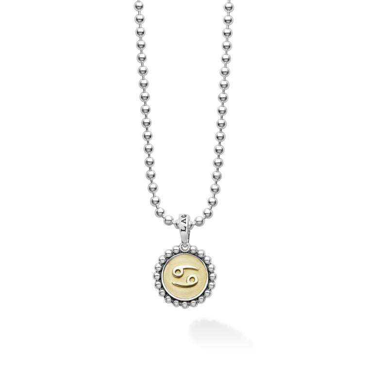 Our Signature Caviar sterling silver and 18K gold Cancer charm finished on a sterling silver ball chain necklace. This zodiac charm represents birthdays from June 21 to July 22.