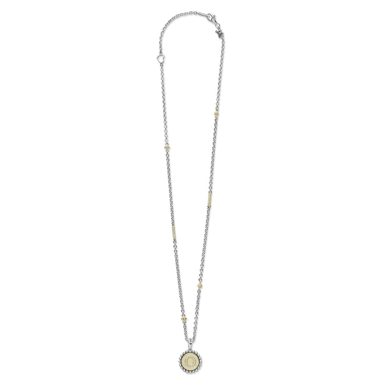 Signature Caviar Q Initial Diamond Charm Necklace features a sterling silver chain with 18K gold accents and a diamond-studded Q pendant, showcasing LAGOS's craftsmanship.