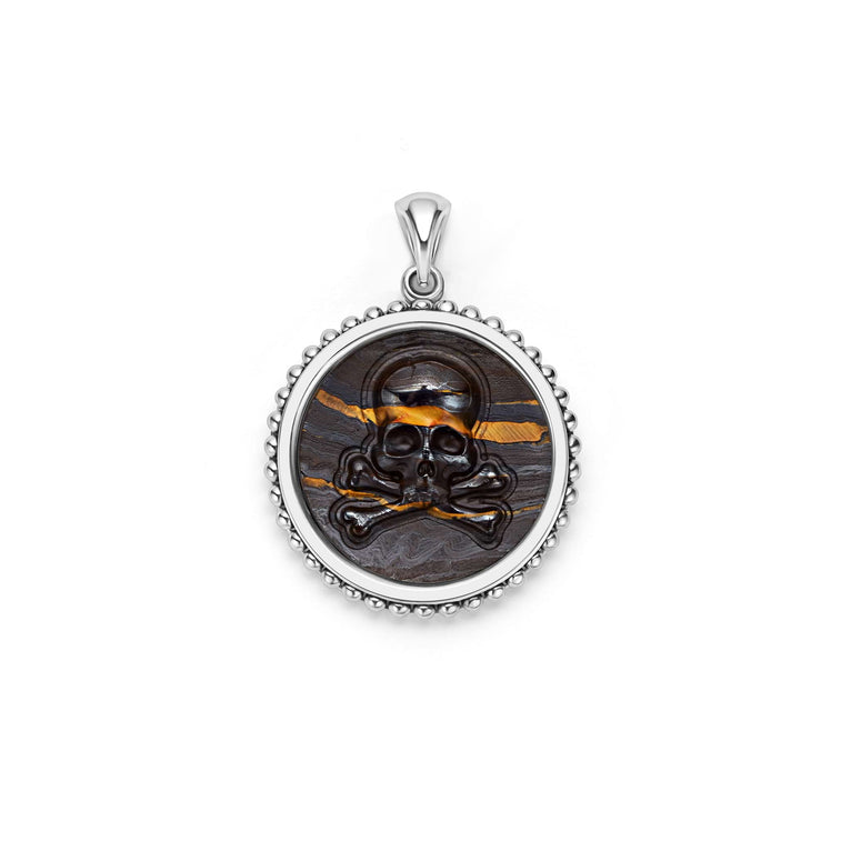 Tiger iron gemstone surrounded by sterling silver Caviar beading form this crossbone emblem amulet.