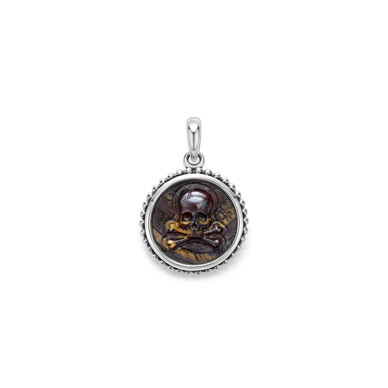 Tiger Iron gemstone surrounded by sterling silver Caviar beading form this crossbone emblem amulet.