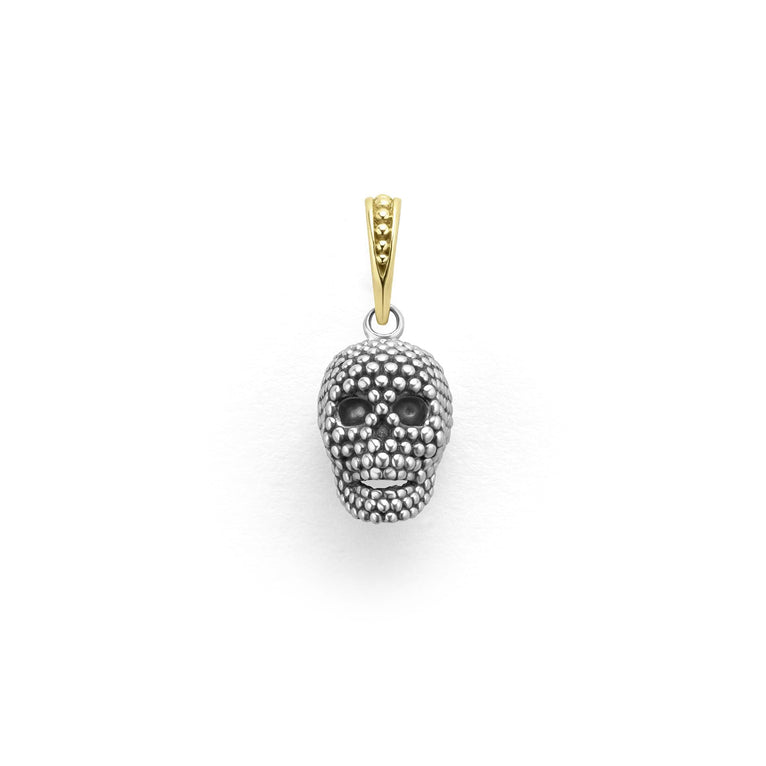 Artfully crafted skull amulet made of sterling silver Caviar beading accented by an 18K gold bale.