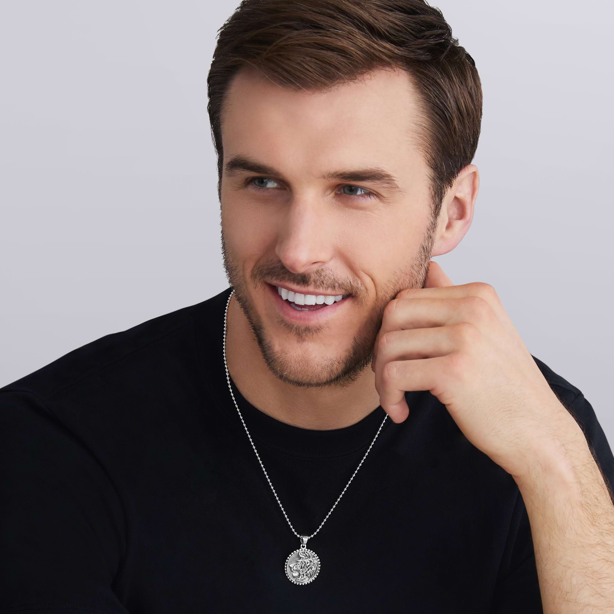 man wearing sterling silver lion design with Caviar beading on the this Silver Lion Circle Amulet