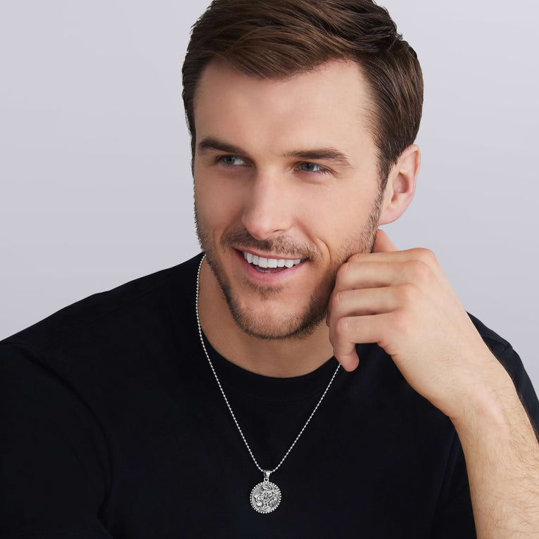 man wearing sterling silver lion design with Caviar beading on the this Silver Lion Circle Amulet