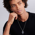 man wearing sterling silver cross amulet detailed with blue sapphires