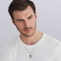 man wearing Ruby Cross Amulet featuring smooth sterling silver with ruby accents
