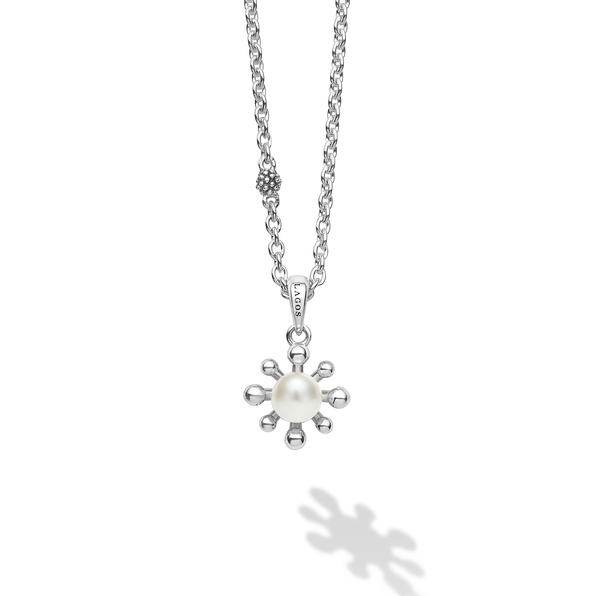 A cultured freshwater pearl framed by fleurs on a sterling silver chain detailed with Caviar spheres.