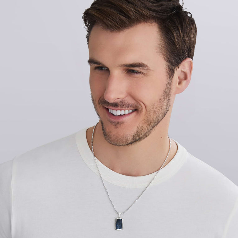 man wearing pietersite tag amulet with sterling silver Caviar beading, 34 × 14 mm