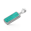 Close-up of turquoise tag amulet framed with sterling silver Caviar beads, universal bale