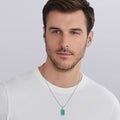 man wearing turquoise tag amulet with sterling silver Caviar beading, 34 × 14 mm