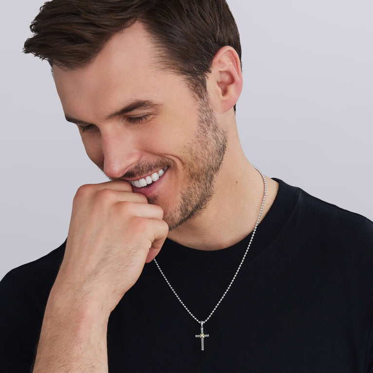 man wearing two-tone caviar beaded diamond cross, featuring 18K gold and sterling silver 