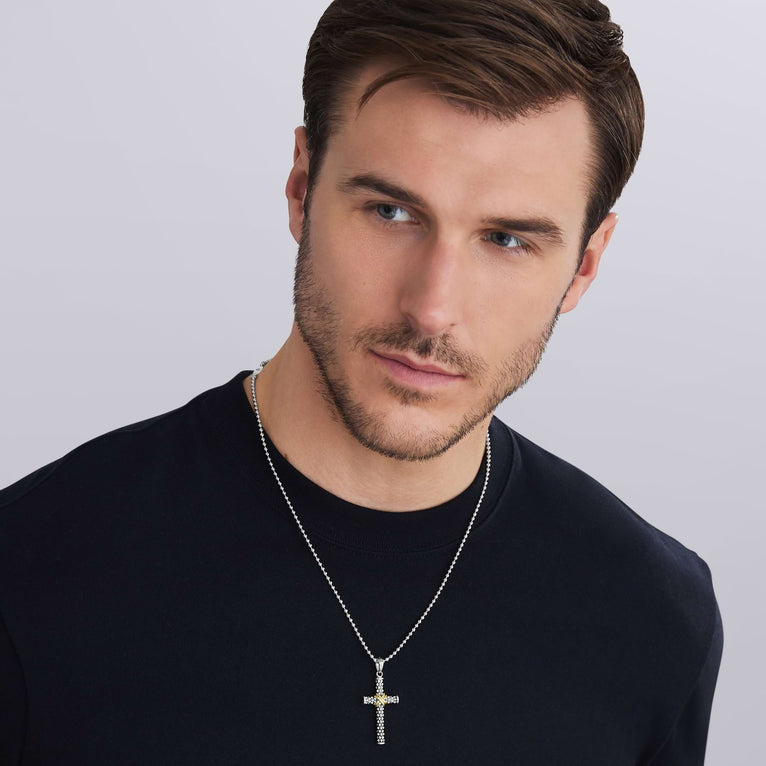 man wearing cross amulet featuring sterling silver and 18K gold with signature Caviar beading
