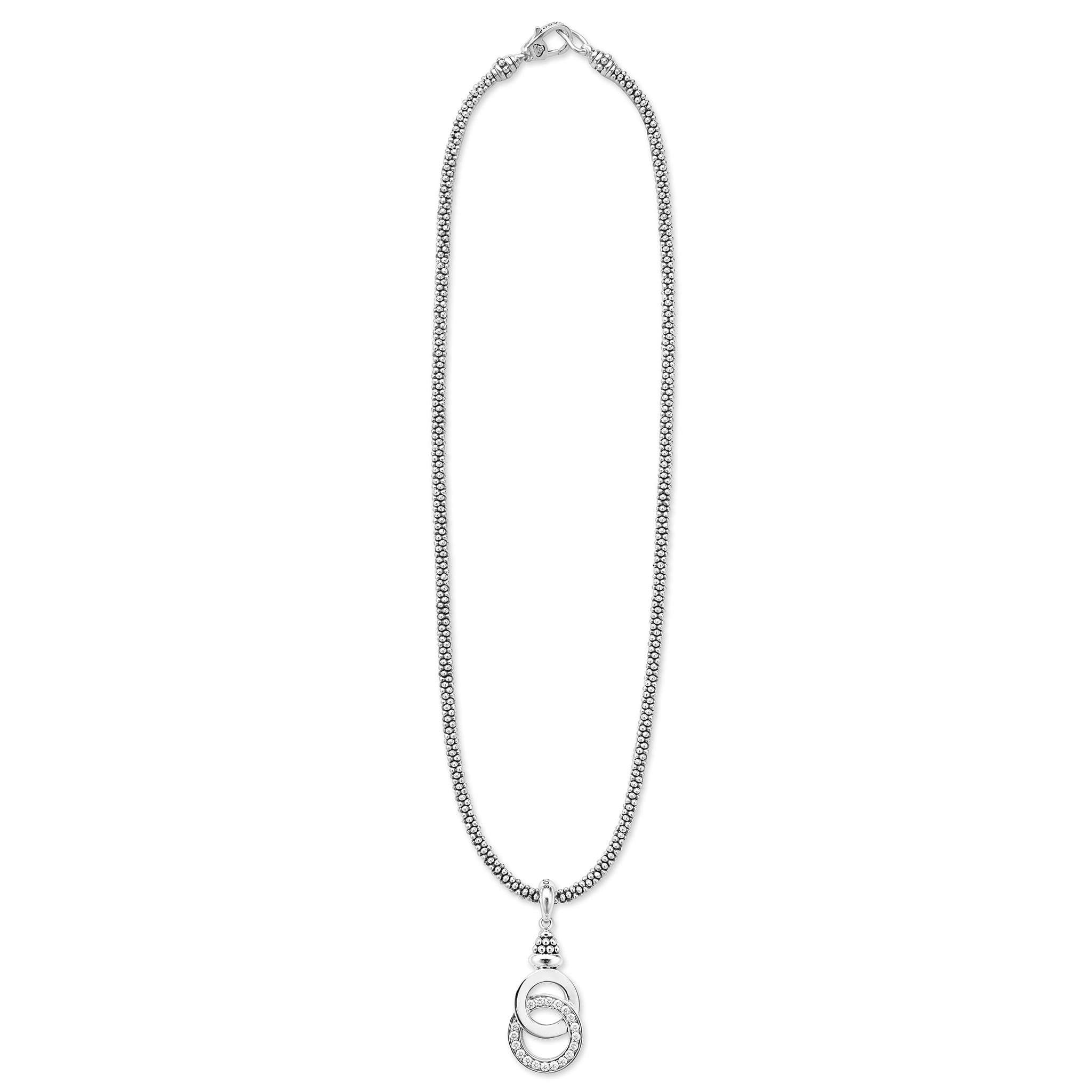 Sterling silver necklace with interlocking rings; one smooth, one with stones, suspended from a beaded chain. Signature Caviar Silver Interlocking Diamond Caviar Pendant Necklace.